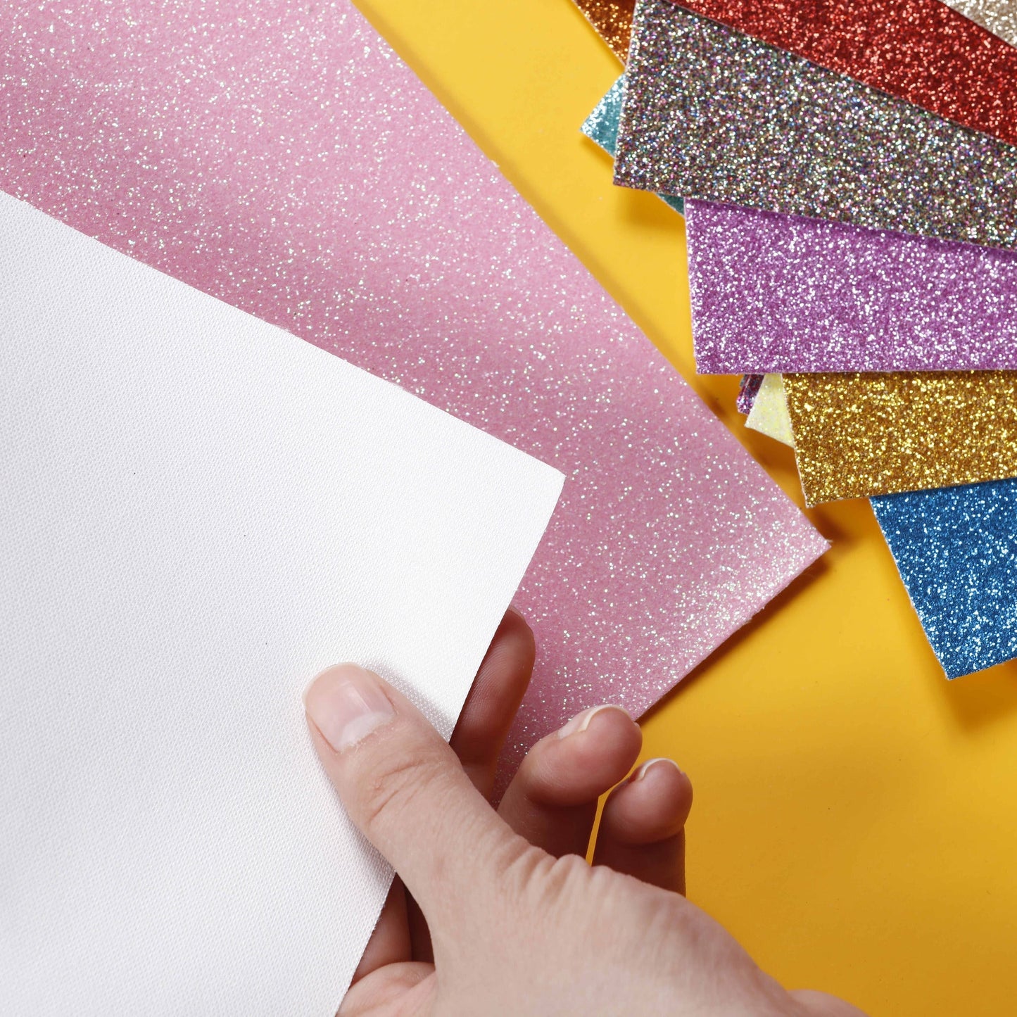 Image of Bulk Faux Leather Sheets in Hand Display | Caption-Bulk Faux Leather Sheets in Hand Display